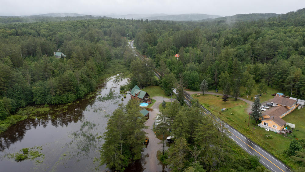 In an aerial view, water covers residential property after heavy rain on July 10, 2023 in Londonderry, Vt.