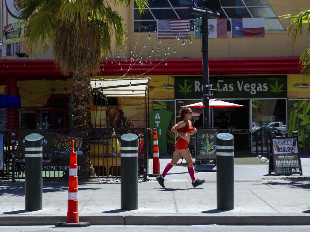 A person jogs on the Las Vegas Strip during a heat advisory on Friday.