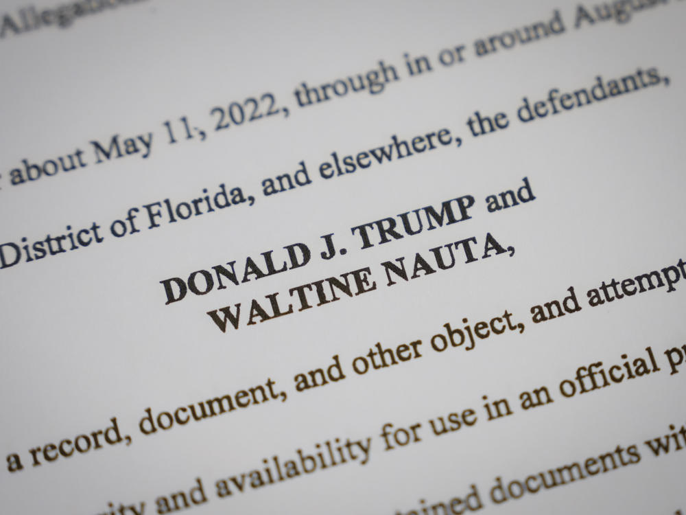 Pages from the unsealed federal indictment of former President Donald Trump. On Monday he asked a Florida judge to delay his trial. Prosecutors asked for it to begin in December.