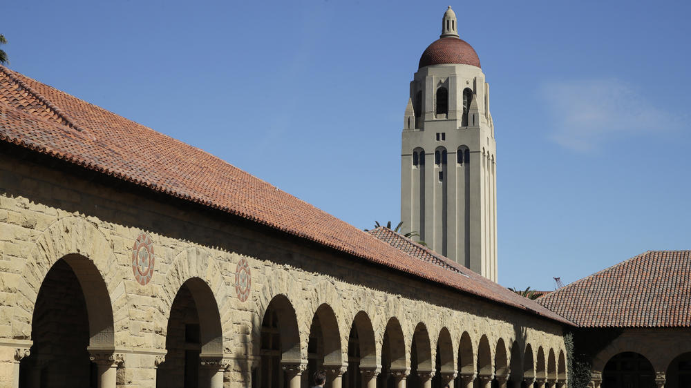 People walk on the Stanford University campus beneath Hoover Tower in Stanford, Calif., on March 14, 2019. The president of Stanford University Marc Tessier-Lavigne said Wednesday, July 19, 2023, he would resign, citing an independent review that cleared him of research misconduct but found flaws in other papers authored by his lab.