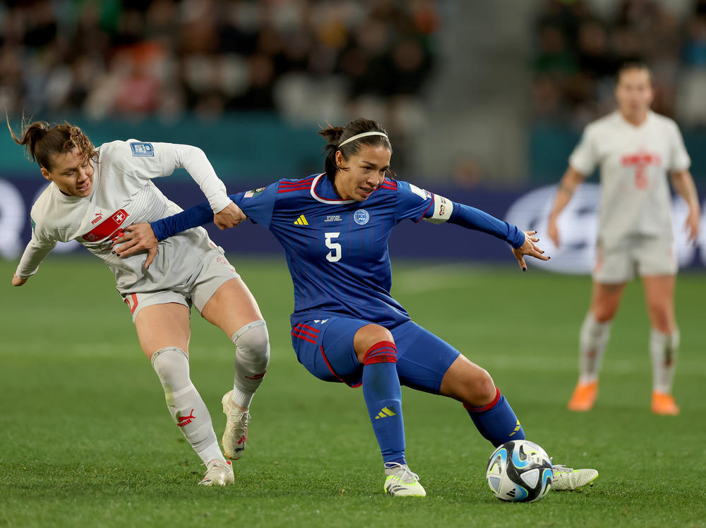 Ramona Bachmann of Switzerland (white) challenges Hali Long of the Philippines (blue) for the ball during the Women's World Cup match in Dunedin, New Zealand on July 21, 2023.