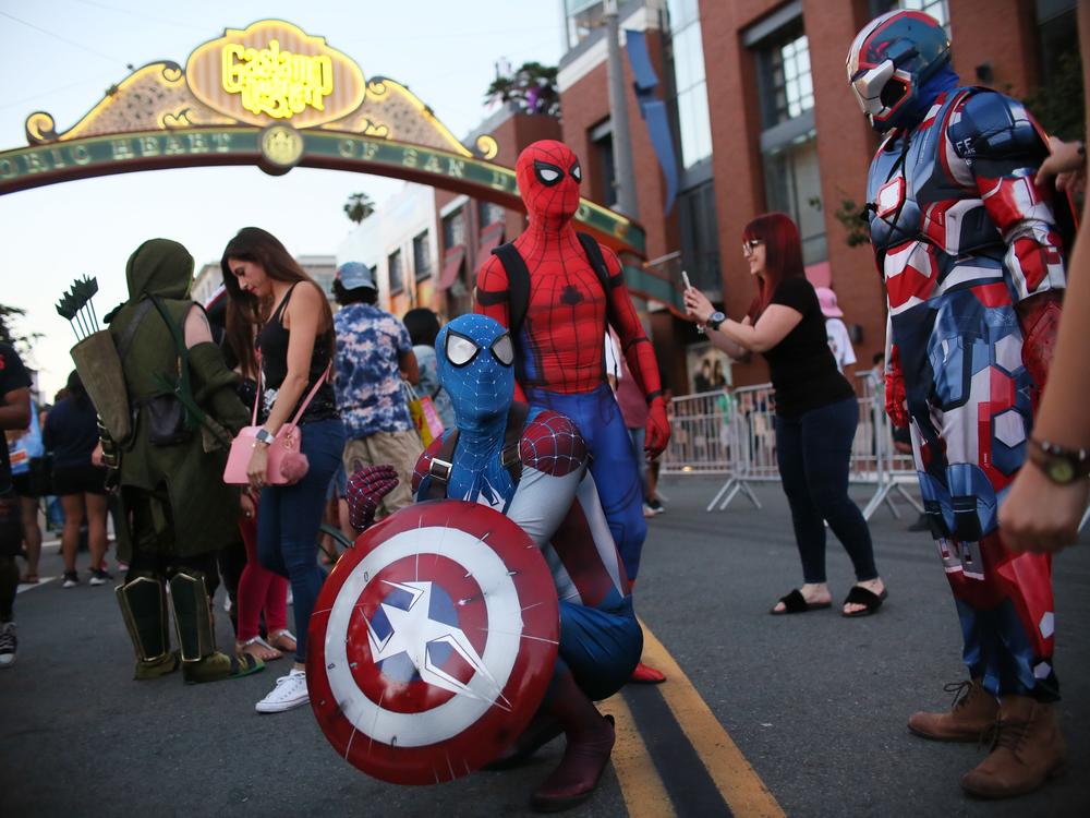 SAN DIEGO, CA - JULY 20: Cosplay characters dressed as Spiderman, pose for pictures along 5th Avenue in the Gaslamp Quarter during Comic Con International in San Diego, California.