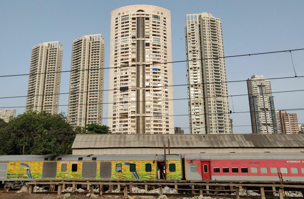 High-rise residential buildings are seen near railway tracks in Mumbai in 2018.