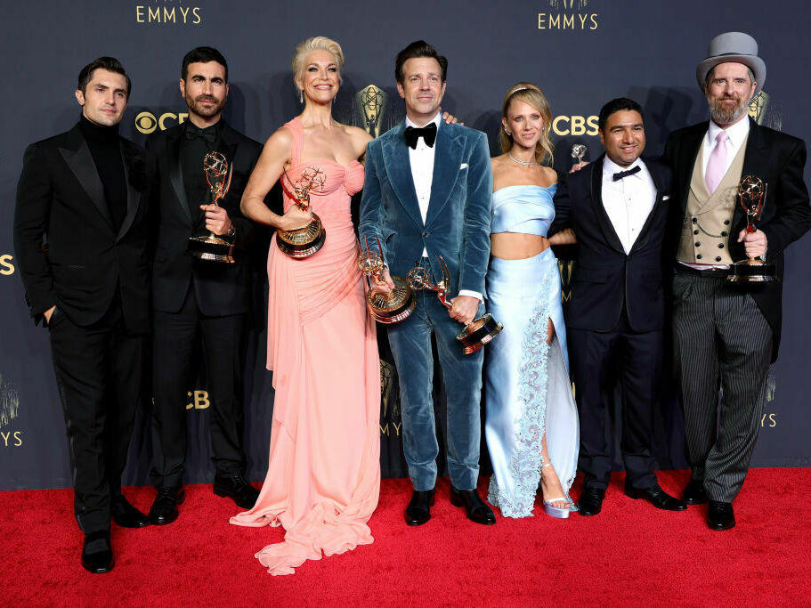 The cast of <em>Ted Lasso</em> pose during the 73rd Emmy Awards in 2021.