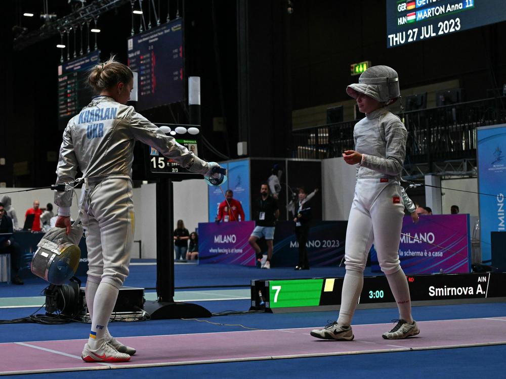 Ukraine's Olha Kharlan (L) refuses to shake hands with Russia's Anna Smirnova, registered as an Individual Neutral Athlete (AIN), after she defeated her during the Sabre Women's Senior Individual qualifiers, as part of the FIE Fencing World Championships on July 27.