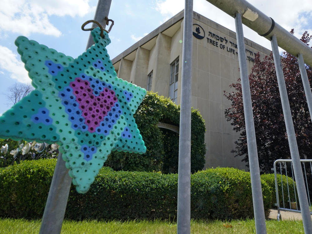 A Star of David hands from a fence outside the dormant landmark Tree of Life synagogue in Pittsburgh in July.
