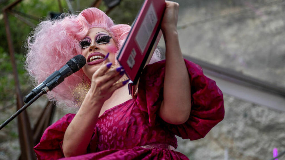 Drag Queen Brigitte Bandit reads a book during a story time reading at the Cheer Up Charlies dive bar on March 11, 2023 in Austin, Texas. Bills to restrict drag performances across the country have failed to make an impact.