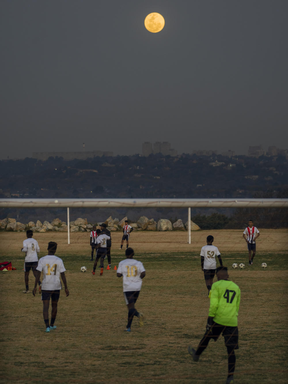 Football players in Johannesburg, South Africa, play with the supermoon rising in the background. The moon appeared bigger and brighter than normal because it was closer to Earth.