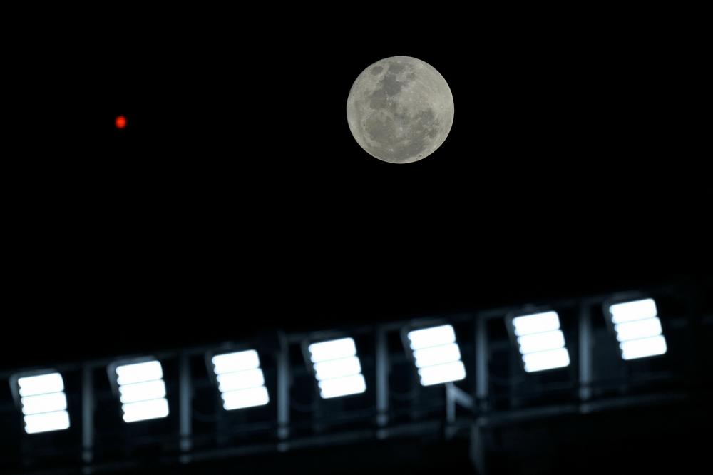 The second supermoon of 2023, also known as the sturgeon supermoon, rises before the start of the Copa Libertadores soccer match at the Mas Monumental stadium in Buenos Aires on Tuesday.