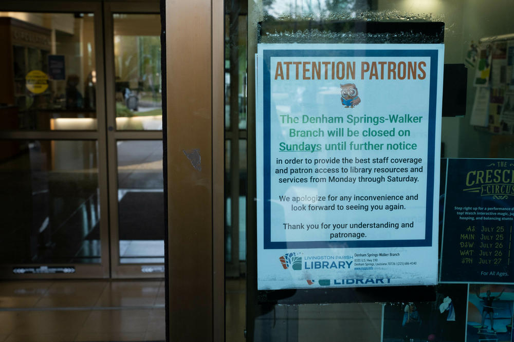A sign on a door at the Denham Springs-Walker Branch library in Livingston Parish announces the elimination of Sunday hours due to staff shortages.