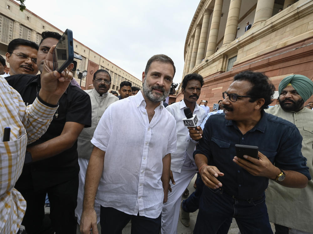 India's top opposition leader Rahul Gandhi, center, arrives at the Parliament in New Delhi, India, Monday. India's Parliament reinstated Gandhi as a lawmaker three days after the country's top court halted his criminal defamation conviction for mocking Prime Minister Narendra Modi's surname.