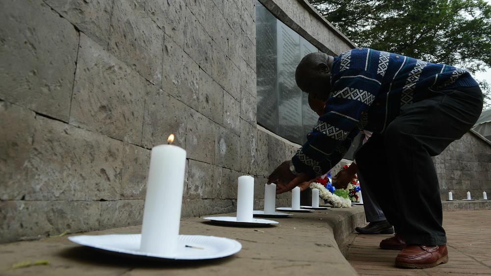 Survivors of the 1998 bombing at the US embassy in Nairobi light candles in front of a monument in memory of the victims in Nairobi on August 7, 2015.