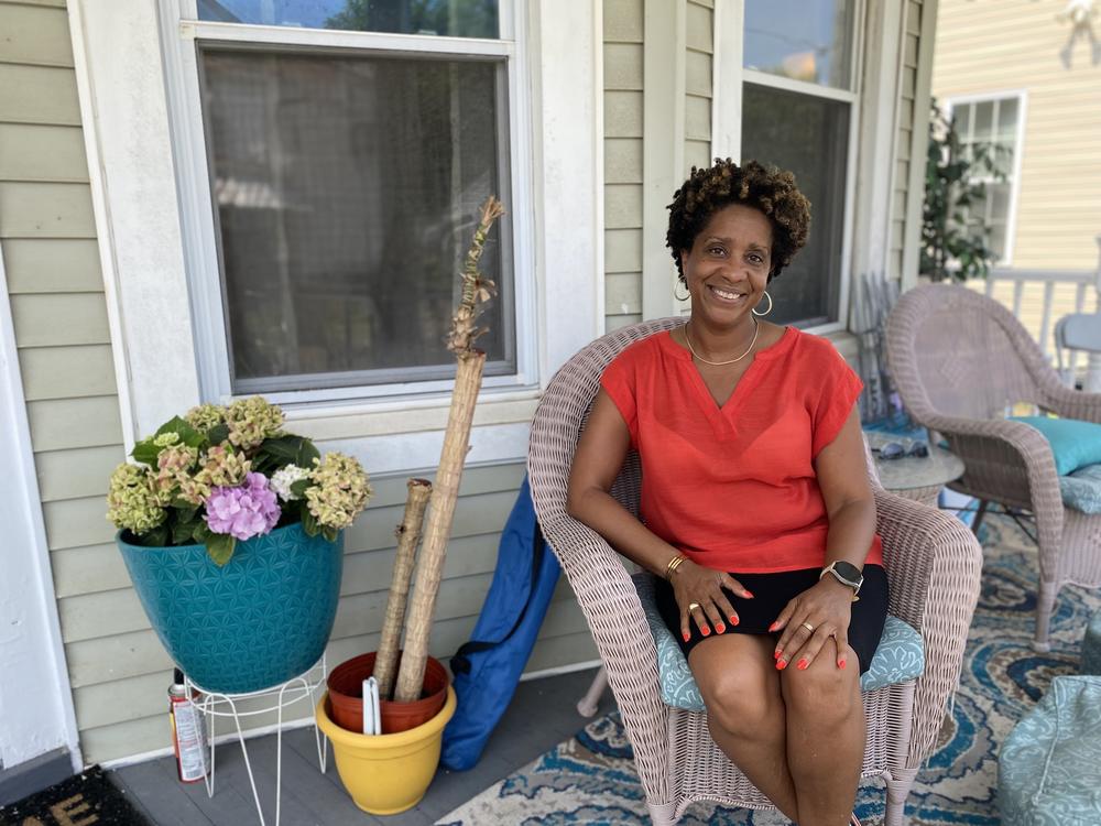 Kim Sudderth, a local climate activist and member of Norfolk's Planning Commission, sits on the porch of her home in the Berkley neighborhood in July.
