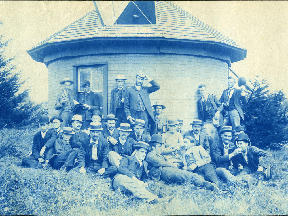 Individuals pose outside of the school's first observatory, circa 1888. The observatory is located behind where Willis House now stands on MSU's campus, just south of Grand River in North Neighborhood.