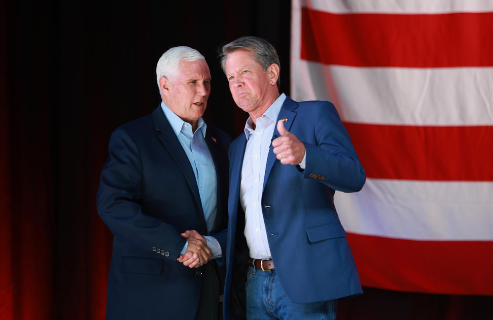 Brian Kemp (right) stands with former Vice President Mike Pence at a campaign event in May, 2022, during his bid for reelection.