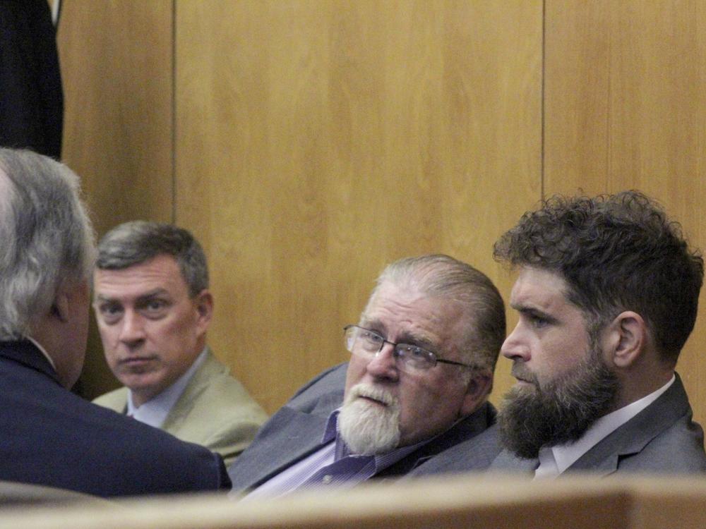 Gregory Case, the father, center, and Brandon Case, the son, right, speak with an attorney, Wednesday, Aug. 16, 2023, at the Lincoln County Courthouse in Brookhaven, Miss.