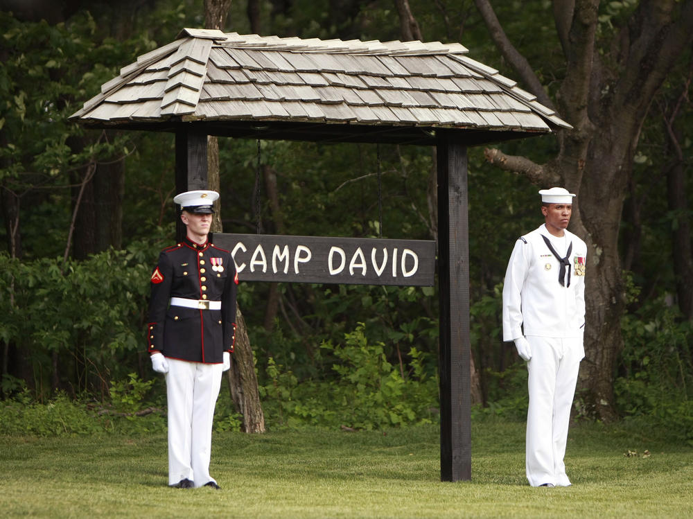 Members of an honor guard stand at attention for the arrival of the Crown Prince of Abu Dhabi to Camp David on June 26, 2008.