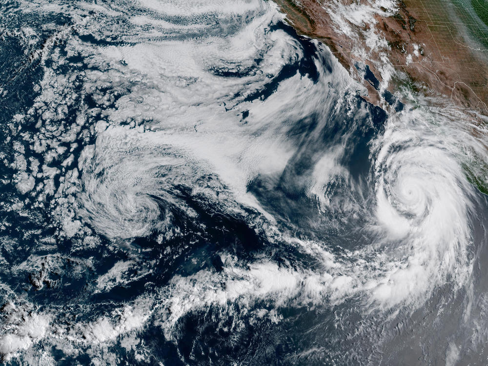 This 1:10 p.m. EDT Friday satellite image provided by the National Oceanic and Atmospheric Administration shows Hurricane Hilary (right) off Mexico's Pacific coast.