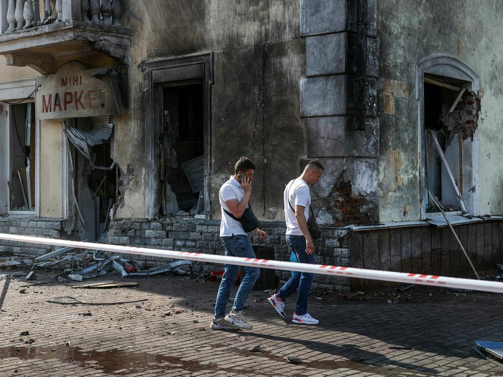 Law enforcement officers inspect the site of a missile strike in Chernihiv, Ukraine, on Saturday.