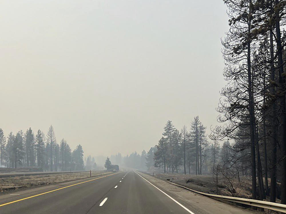 This photo provided by WSDOT East (Washington State of Transportation) smoke from wildfires fill the sky at Salnave/SR 902 interchange in Spokane County, Wash., on Saturday.