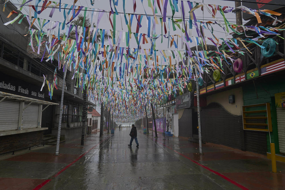 Sun., Aug. 20: A man crosses a street after the landfall of Tropical Storm Hilary in Rosarito, Mexico.