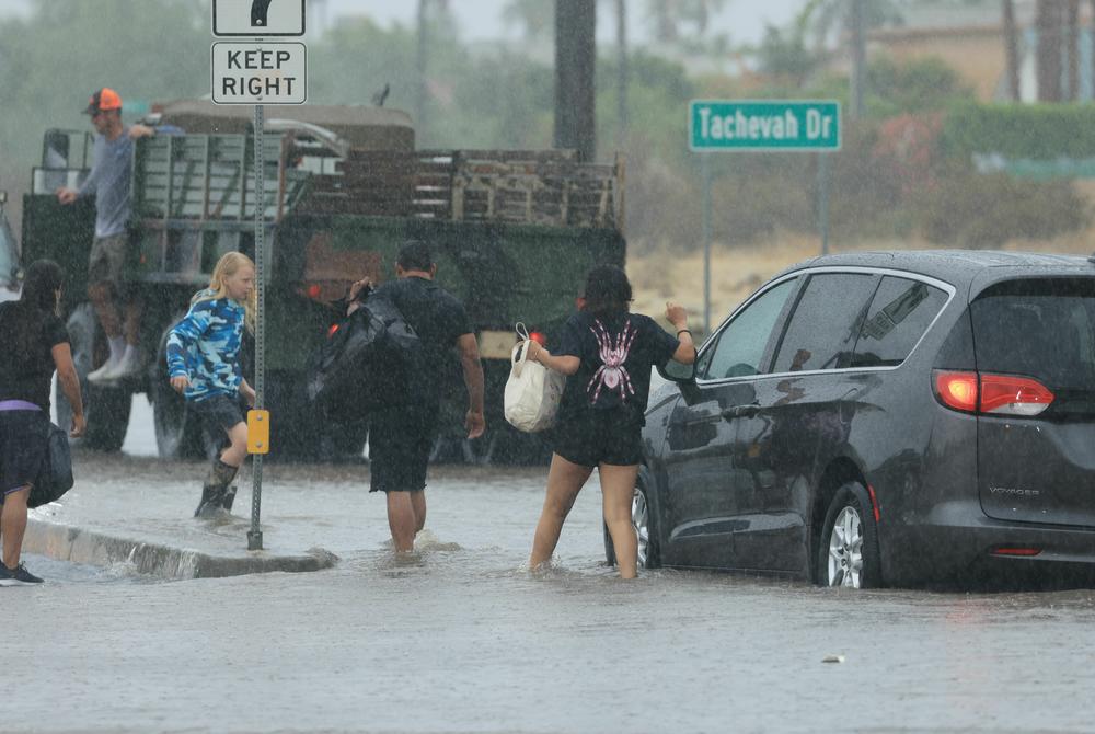 Sun., Aug. 20: Motorists leave their vehicle stuck on a flooded road during heavy rains from Tropical Storm Hilary in Palm Springs, California.