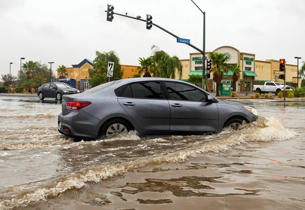 Sun., Aug. 20: A vehicle drives through a flooded intersection as tropical storm Hilary makes landfall in Palm Springs, California.