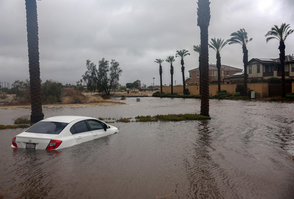 Sun., Aug. 20: A car is partially submerged in floodwaters as Tropical Storm Hilary moves through the area in Cathedral City, California.