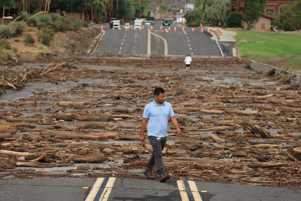 Mon., Aug. 21: A worker from the Coachella Valley Water Department surveys the debris flow following heavy rains from Tropical Storm Hilary, at Thurderbird Country Club in Rancho Mirage, California.