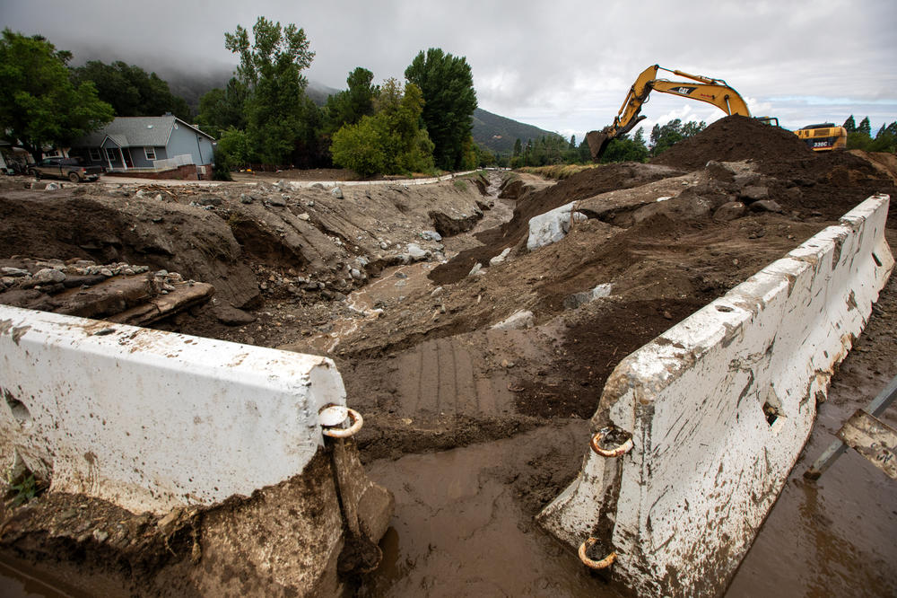 Mon., Aug. 21: Heavy equipment is moving med debris in Oak Glen, California. There were mudflows and flooding overnight in the Oak Glen community from tropical storm Hillary.
