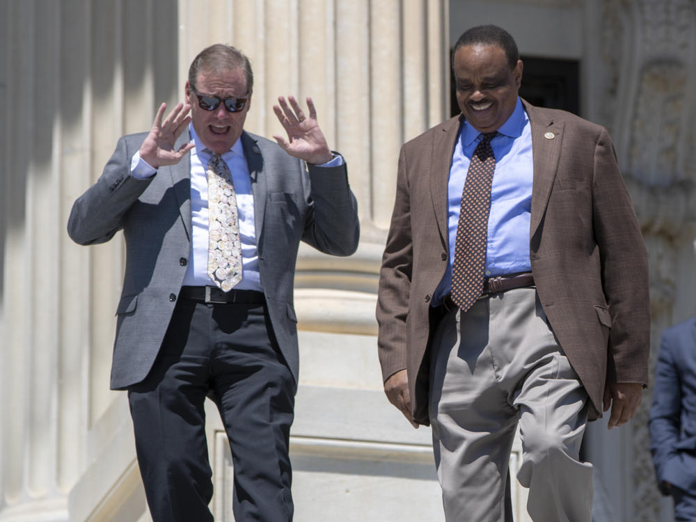 Rep. Neal Dunn, R-Fla., left, and former Rep. Al Lawson, D-Fla., center, are seen exiting the Capitol in Washington on June 15, 2018. After redistricting changed Florida's congressional districts, Dunn defeated Lawson in the 2022 election.