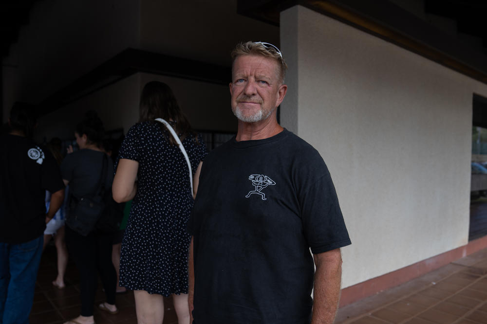 Lahaina resident Curt Hanthorn stands in a long line at the post office picking up his mail for the first time in two weeks. He says it is difficult to focus on daily tasks after the wildfires.