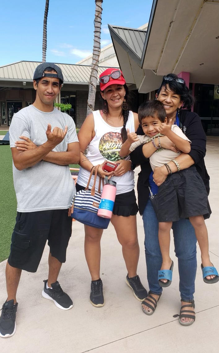 Amanda Vierra (center) with her boyfriend, son, and mother, the first time she saw her mom after the fire. Vierra lived in Lahaina with her boyfriend, whose family lost three homes, including one of the oldest in the town. None were insured.
