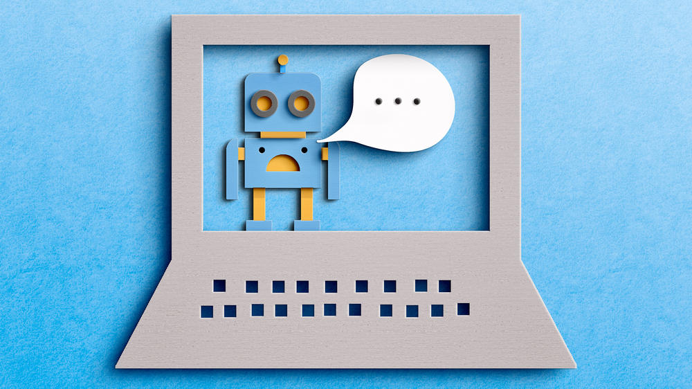 A graphic of a robot with a speech bubble inside of a laptop computer.