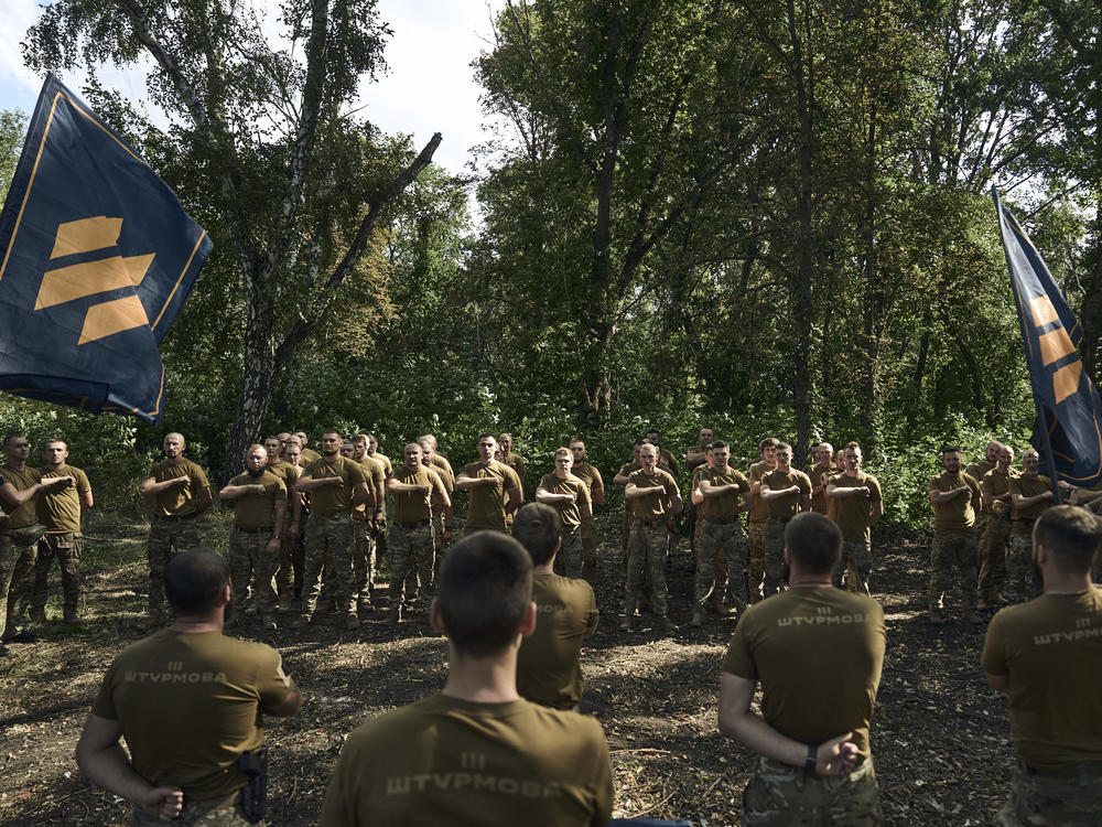 Soldiers of Ukraine's 3rd Separate Assault Brigade shout slogans as they stand in line near Bakhmut, the site of fierce battles with the Russian forces in the Donetsk region, Ukraine, on Sunday.
