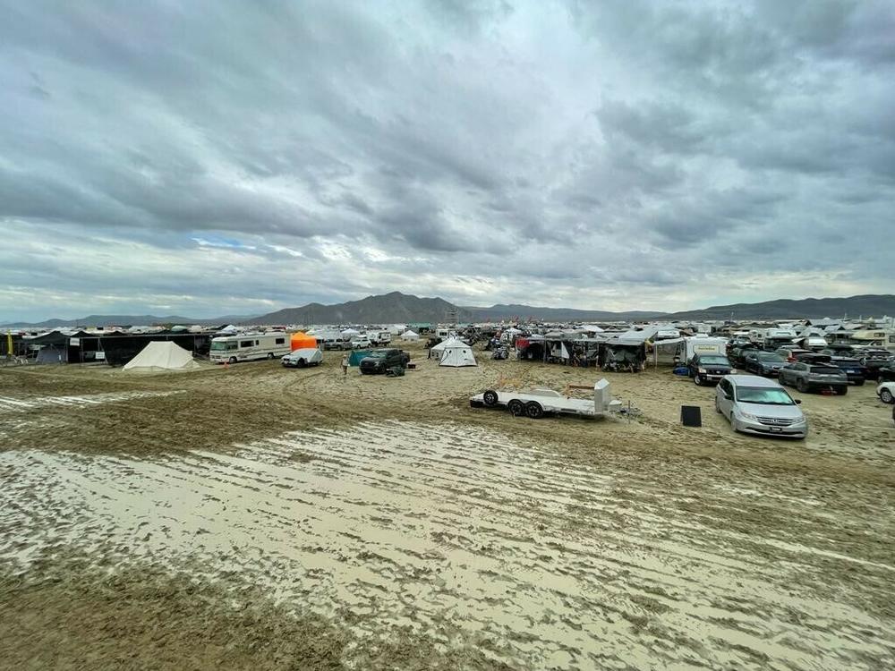 Camps are set on a muddy desert plain on Saturday after heavy rains turned the annual Burning Man festival site in Nevada's Black Rock desert into a mud pit.