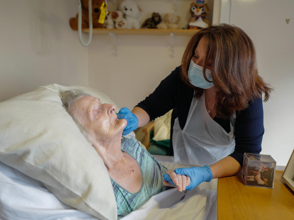 Della Lilley visits with her mother, 89-year old Betty Whiteman at a nursing home during the COVID-19 pandemic.