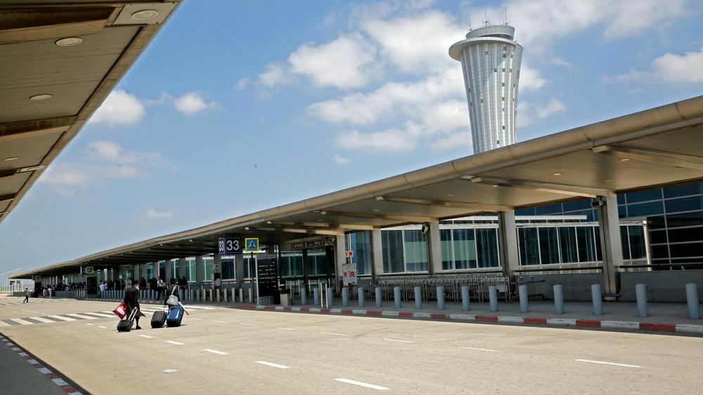 Departing passengers roll their suitcases at the nearly deserted Ben Gurion airport in Lod, near the Israeli coastal city of Tel Aviv, on May 13, 2021.