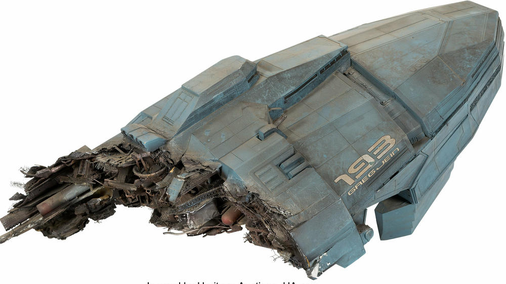 Greg Jein's name appears on this ruined spacecraft from the First Bug War in the 1997 film <em>Starship Troopers</em>. The model miniature is nearly three feet long, made to look as if an intense battle has left its hull shredded.
