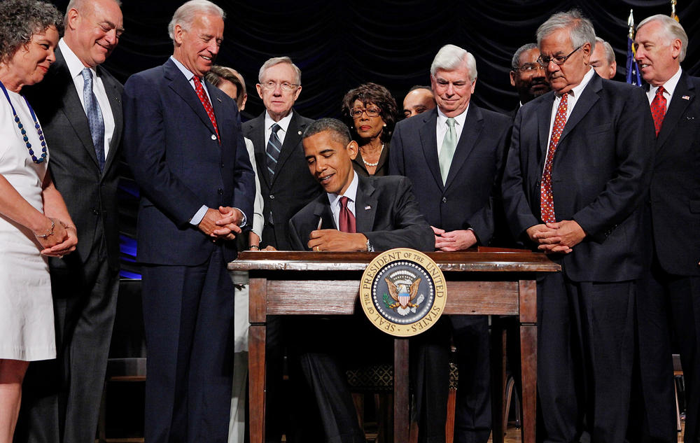 President Barack Obama signs the Dodd–Frank Wall Street Reform and Consumer Protection Act into law at the Ronald Reagan Building and International Trade Center on July 21, 2010, in Washington, D.C.