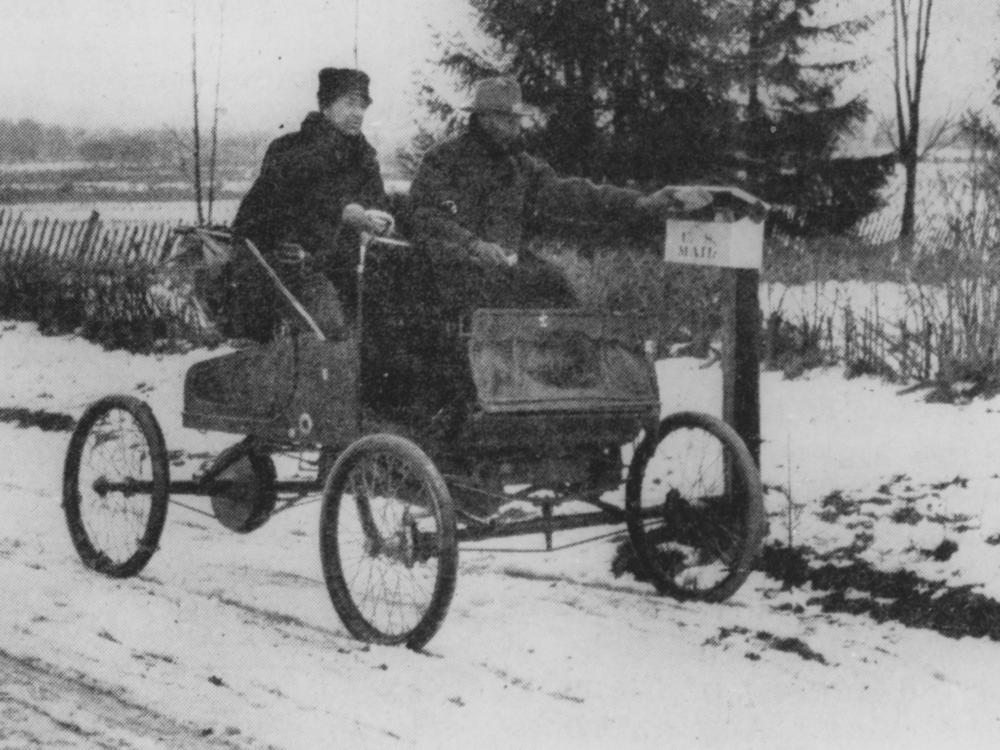 A rural mail carrier in 1905 trying out new transportation technology.