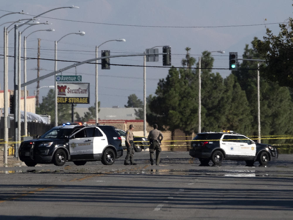 Police cars block off a street where a sheriff's deputy was shot while in his patrol car in Palmdale, Calif. on Sunday, Sept. 17, 2023.