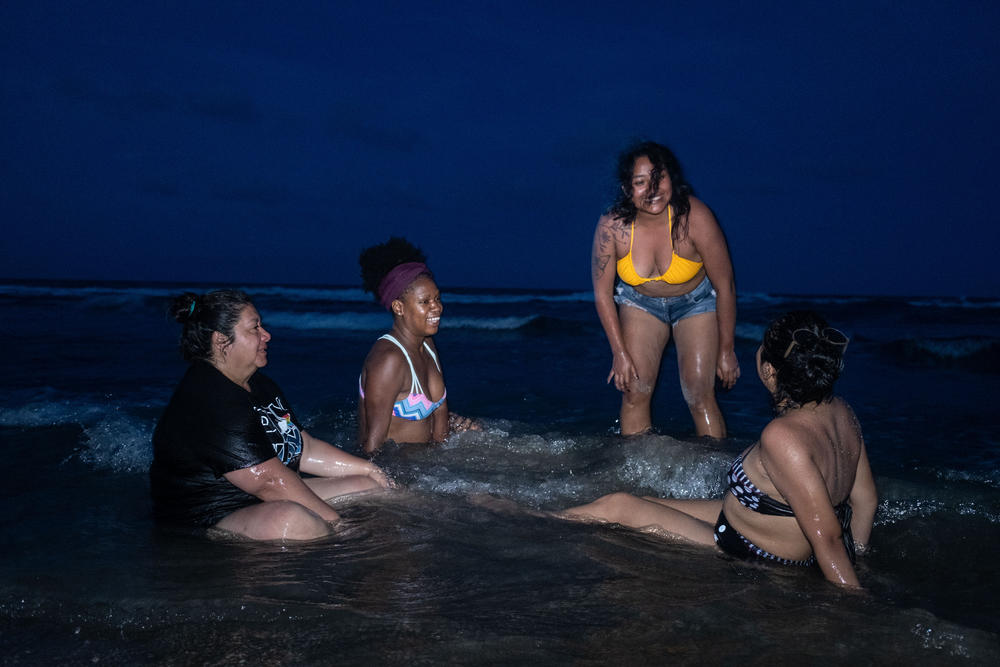 Cecilia Estrada, Odalys Gonzalez, Alitzel Diaz and Jessica Tomas after the Afro-Mexican women's meeting, rest on Tamiahua beach at sunset on July 23.