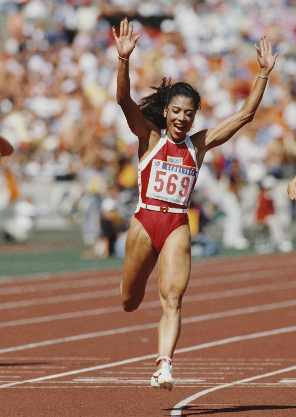 Florence Griffith-Joyner celebrates winning gold in the Women's 100 meters final event during the 1988  Summer Olympic Games in Seoul, South Korea.