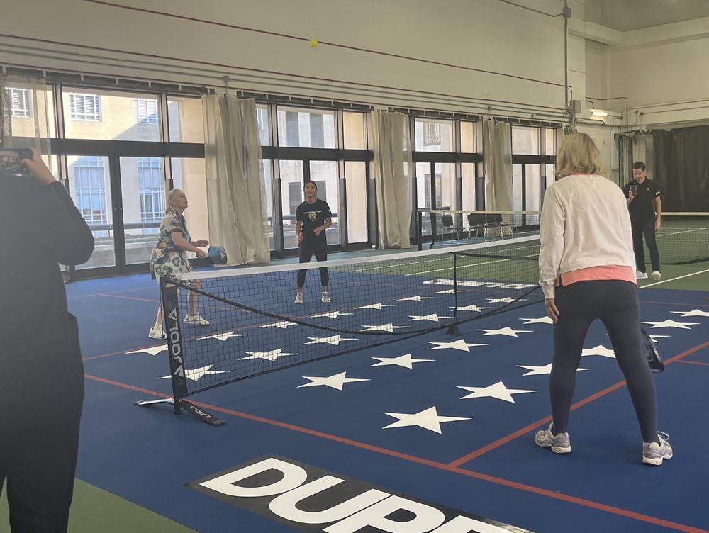 Senator Kirstin Gillibrand, D-N.Y., (on left) faces off against Sen. Cynthia Lummis, R-Wy., (on right) with members of the D.C. professional pickleball team at an event with the Senate pickleball caucus.