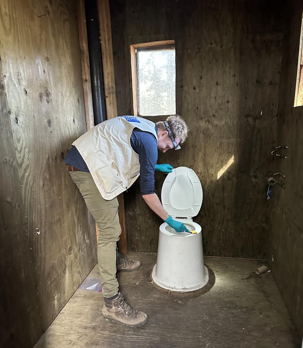 EIS officer Arran Hamlet swabs a backcountry pit latrine for norovirus sampling during an investigation for an outbreak of gastrointestinal illness among Pacific Crest Trail Hikers in 2022.