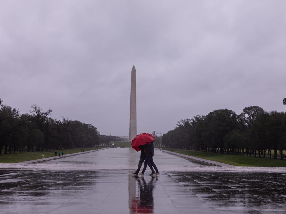 People walk through the rain on the steps of the Lincoln Memorial on Saturday, Sept. 23, 2023, in Washington, D.C.