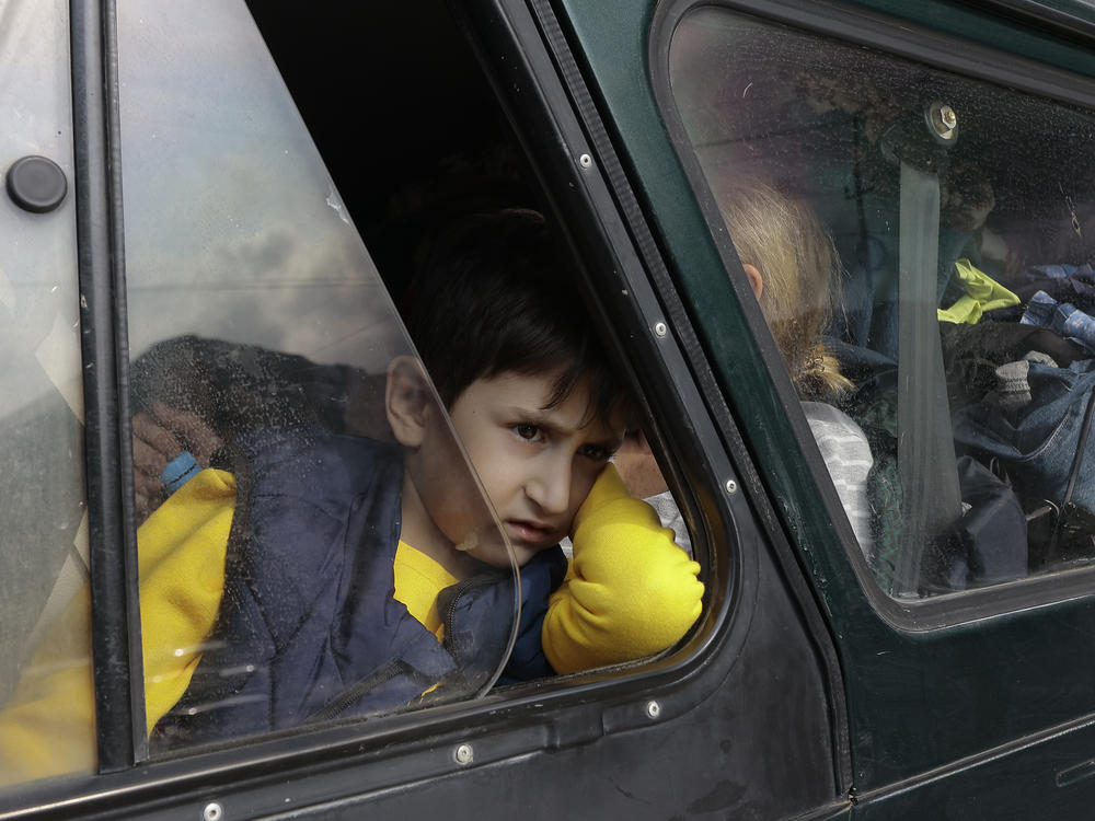An ethnic Armenian boy from Nagorno-Karabakh looks on from a car upon arrival in Armenia's Goris, in the Syunik region, Armenia, on Monday. Thousands of Armenians have streamed out of Nagorno-Karabakh after the Azerbaijani military reclaimed full control of the breakaway region last week.