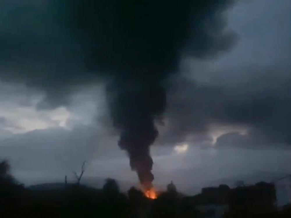This grab taken from video distributed by Siranush Sargsyan's Twitter account on Monday shows smoke rising after a fuel depot explosion near Stepanakert, Nagorno-Karabakh. Several dozen people were injured at a gas station just outside of the breakaway region's capital, Stepanakert, where a fuel tank exploded.