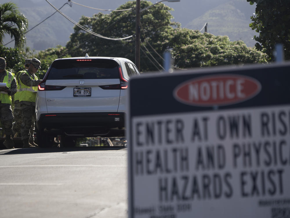 The Hawaii National Guard checks on a car passing the checkpoint on Kaniau Street on Monday, Sept. 25, 2023, in Lahaina, Hawaii.